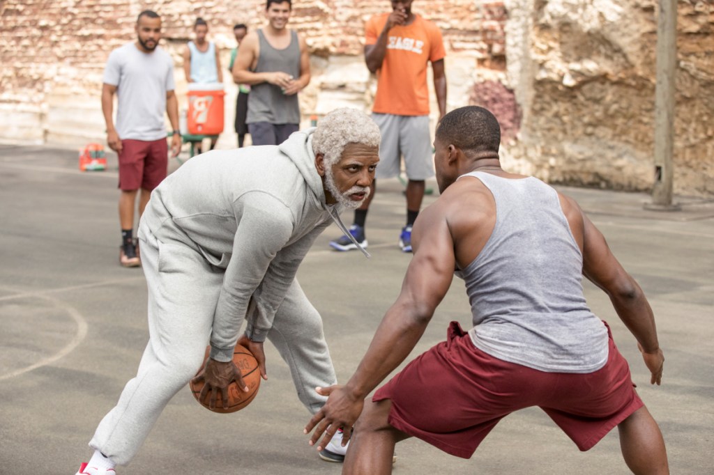 This image released by Lionsgate shows Boston Celtics guard Kyrie Irving, left, portraying Uncle Drew in a scene from the comedy "Uncle Drew."