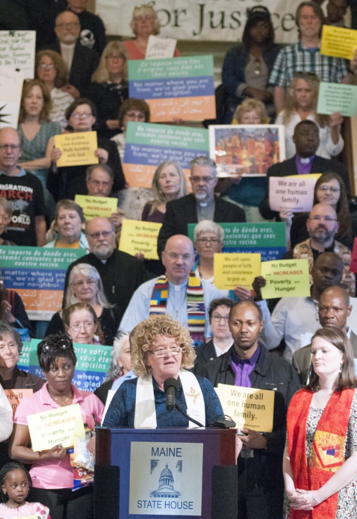 The Rev. Carie Johnsen, of the Unitarian Universalist Community Church in Augusta, speaks at a on June 7, 2017, rally about immigration led by religious leaders in the State House Hall of Flags in Augusta. Rallies in Augusta and Farmington this Saturday are part of a nationwide protest against Trump immigration policies.