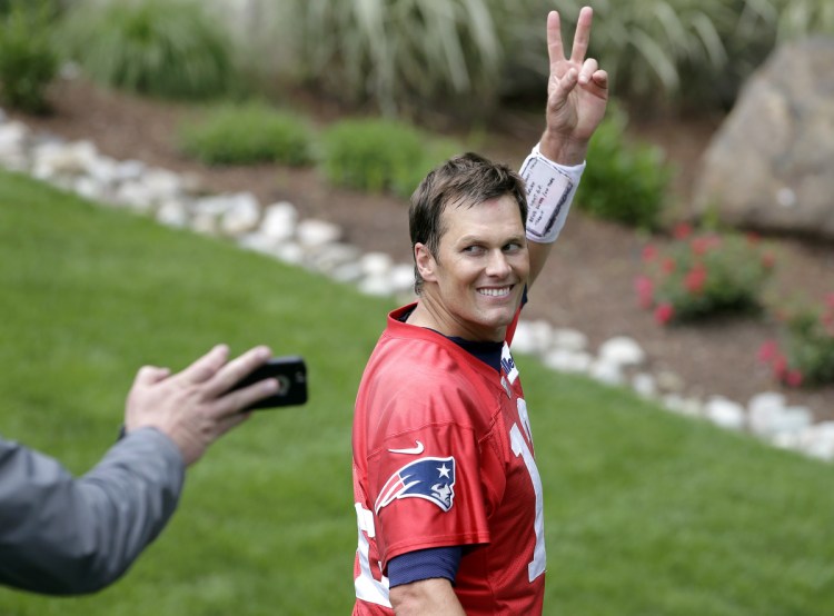 New England Patriots quarterback Tom Brady waves as he steps off the field following a June 7 minicamp practice in Foxborough, Massachusetts.