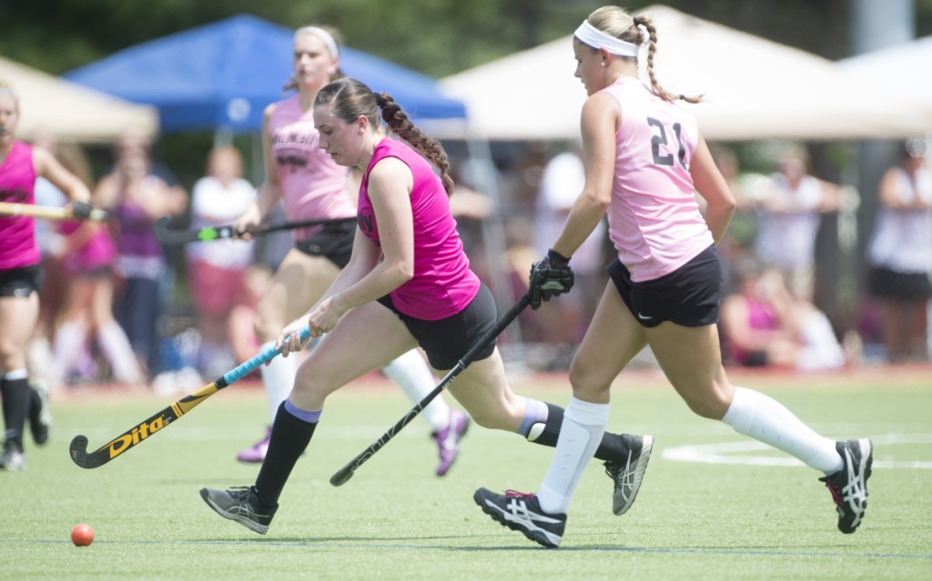 South All-Star Maddison LeBeau (21) chases North All-Star's Addi Williams in the  McNally Senior All-Star field hockey game Saturday at Thomas College in Waterville.