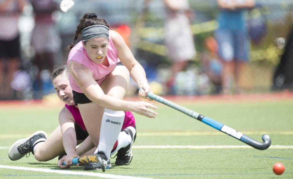 South All-Star's Sydney Meredith-Pickett, front, clears the ball after colliding with North All-Star's Addi Williams at the McNally Senior All-Star field hockey game Saturday at Thomas College in Waterville.