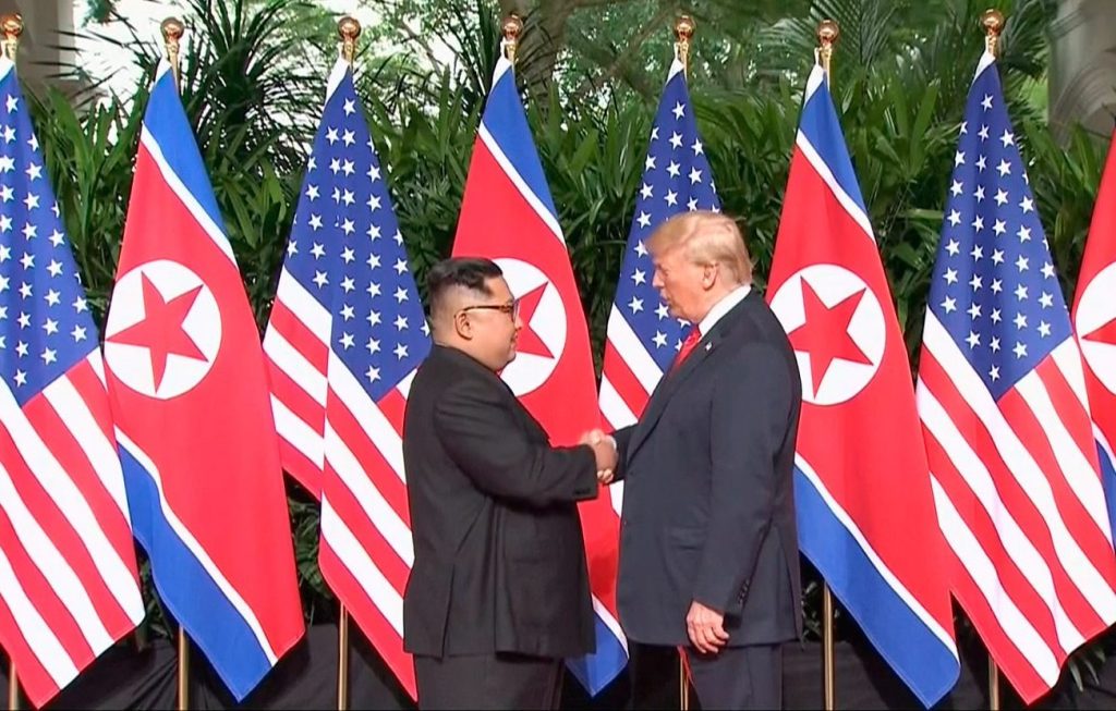 U.S. President Trump and North Korean leader Kim Jong Un shake hands at the start of of their meeting at Capella Hotel in Singapore on Tuesday.