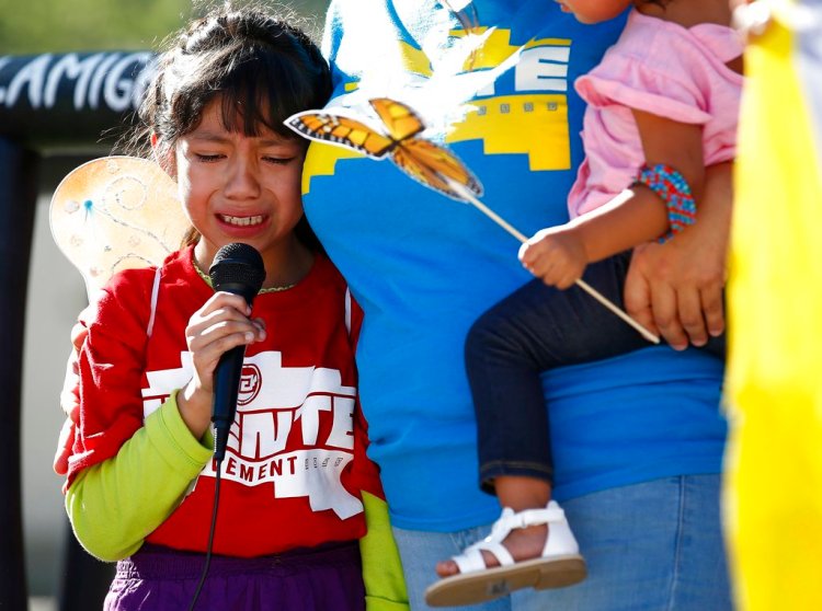Akemi Vargas, 8, cries as she talks about being separated from her father during an immigration family separation protest in front of the Sandra Day O'Connor U.S. District Court building in Phoenix on Monday. 