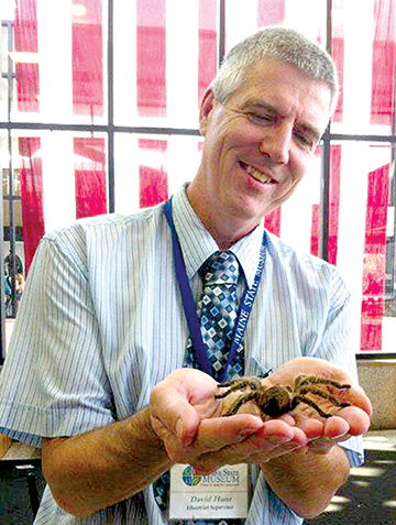 Museum Educator Dave Hunt gets up close with a tarantula at the Maine State Museum’s Bug Maine-ia, to be held this year on Tuesday, September 11.  Maine State 
Museum Photo