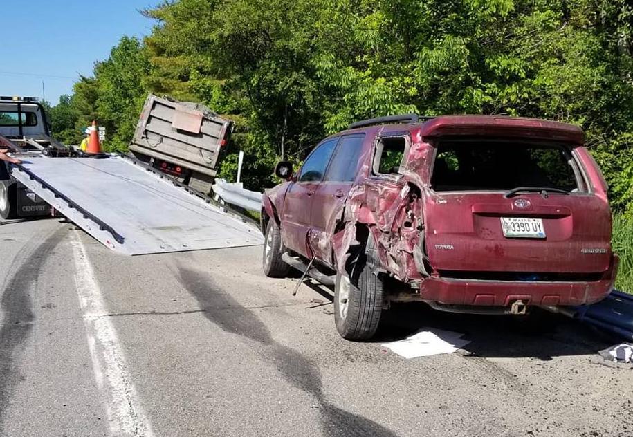 A dump truck carrying a load of reclaimed asphalt slammed into the left rear of this SUV Wednesday morning.