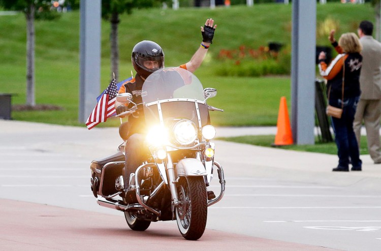 Wisconsin Gov. Scott Walker rides a Harley-Davidson motorcycle in 2013. Walker owns a 2003 Harley Road King  that he's driven across the state to promote tourism and his own political ambitions.