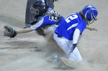Madison's Lauria LeBlanc, right, slides home with a run during the Class C South regional final Tuesday night in Standish.