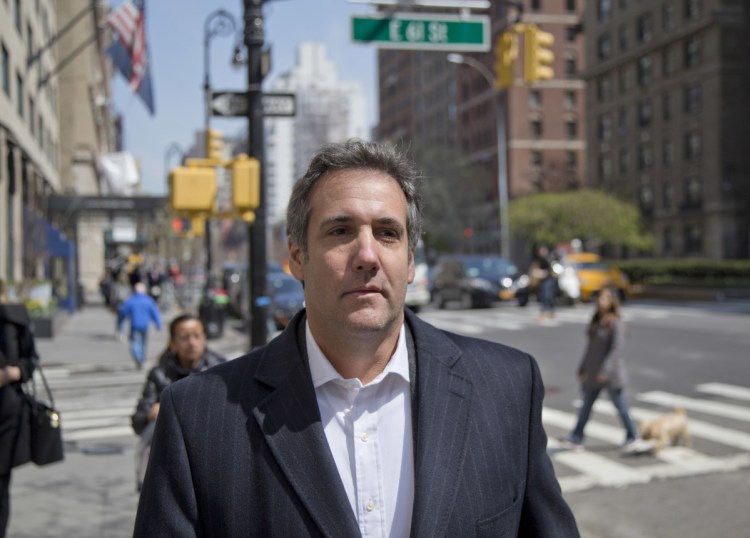 Attorney Michael Cohen walks down the sidewalk in New York. Cohen, President Trump's longtime personal lawyer who is under investigation by federal prosecutors in New York, said he planned on putting "family and country first" in his dealings with the Mueller investigation.