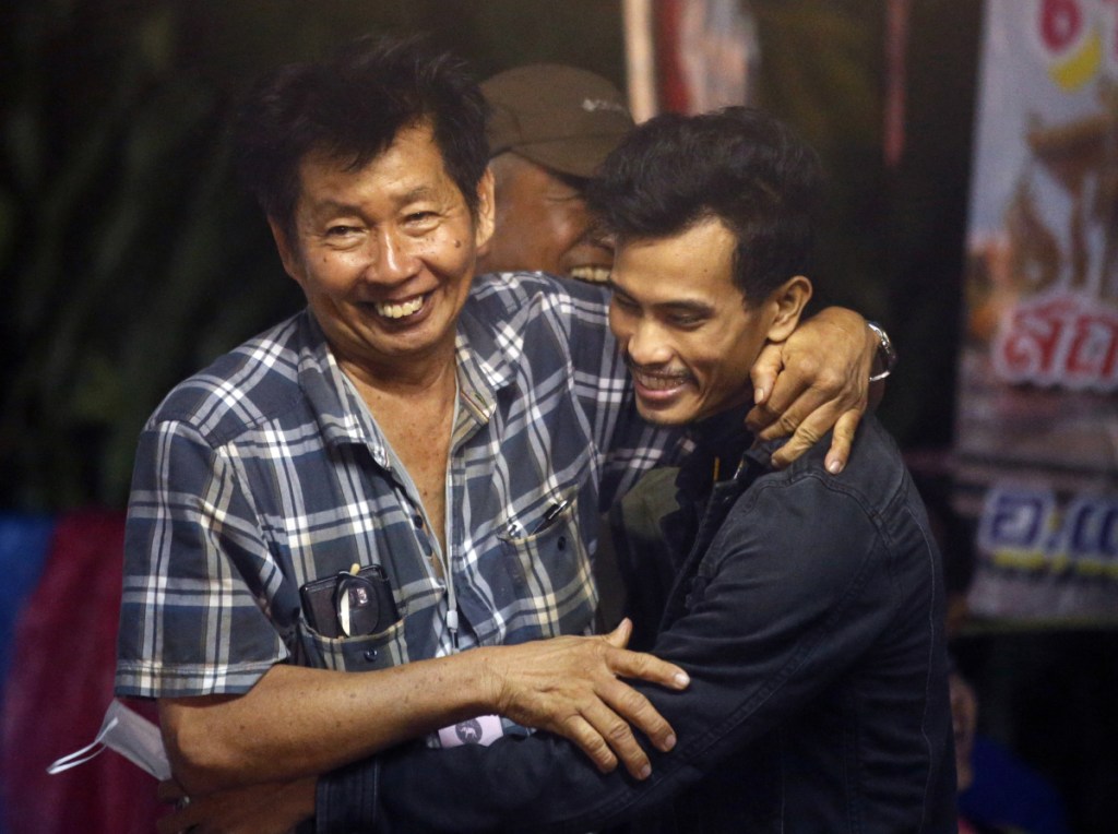 Family members smile after hearing the news that the missing 12 boys and their soccer coach have been found alive, in Mae Sai, Chiang Rai province, in northern Thailand on Monday.