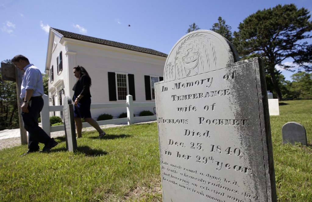 A grave stone stands on Mashpee Wampanoag land on Cape Cod. The tribe says an unfavorable decision from the U.S. Interior Department would effectively shut down certain government operations, including the tribe's new court system and police force.