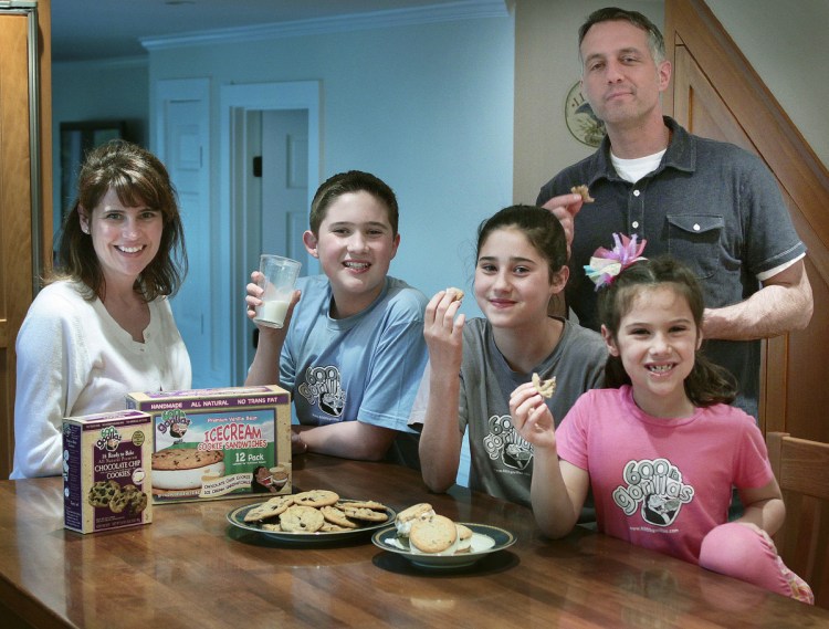 Paula, left, and husband Chris White, right, pose with their children and some of their 600 lb Gorillas frozen ice cream sandwiches and cookies in Duxbury, Mass., in 2011.