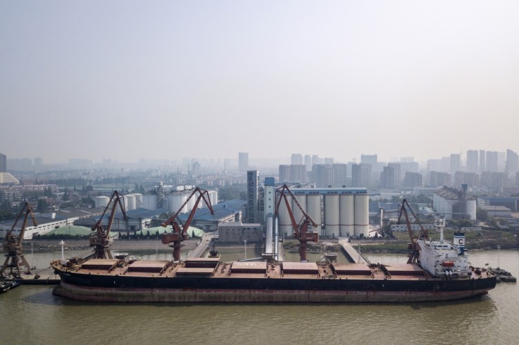 A ship unloads grain in Nantong, China. Farmers in the American Midwest fear a tariff battle will cost them access to China's lucrative markets.