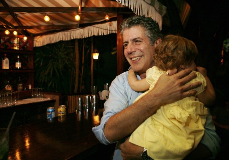 Anthony Bourdain holds his daughter Ariane in Miami Beach in 2008. Bourdain was worth $1.2 million when he died last month.
Most of the estate has been left to his daughter, who is now 11.