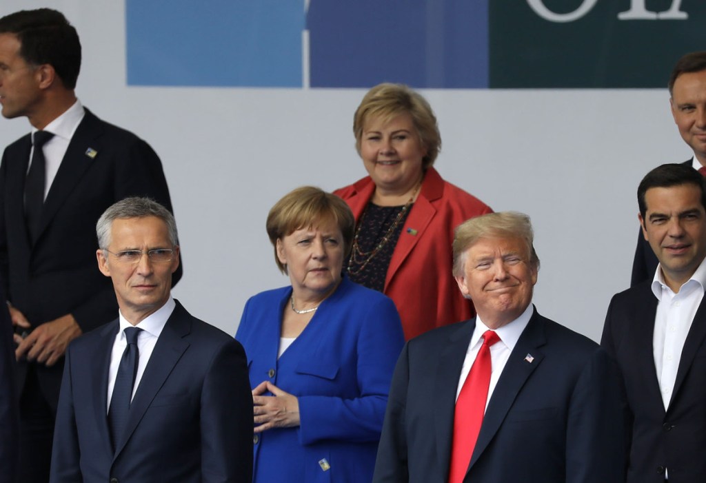 President Trump, German Chancellor Angela Merkel, center, and NATO Secretary General Jens Stoltenberg, left, stand for a photo during the NATO summit in Brussels on Wednesday.