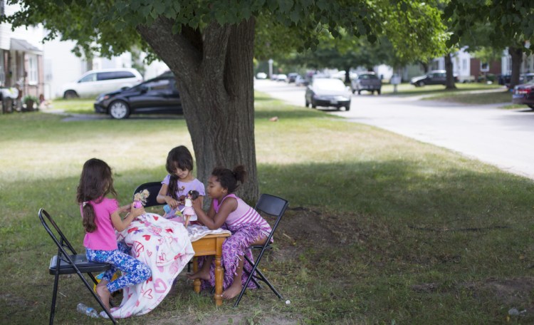 Neighborhood girls play with dolls in a yard at Sagamore Village in Portland, near the proposed site of a new homeless service center. About 80 percent of Nason's Corner's 3,580 residents are homeowners, according to 2015 Census data.