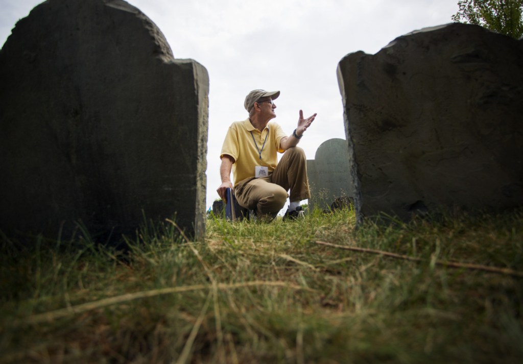 PORTLAND, ME - JULY 14: Volunteer Dave Smith kneels between gravestones while giving a tour of Eastern Cemetery in Portland on Saturday, July 14, 2018. The hour-long tours, at 11 a.m. on Saturdays, Wednesdays, Sundays and 5:30 p.m. on Thursdays, are part of summer offerings during the cemetery's 350th annivesary. (Photo by Derek Davis/Staff Photographer)