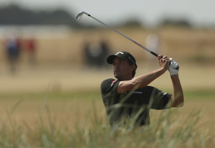 Kevin Kisner plays out of the rough on the 18th hole during the first round of the British Open golf championship in Carnoustie, Scotland, on Thursday. (AP Photo/Jon Super)