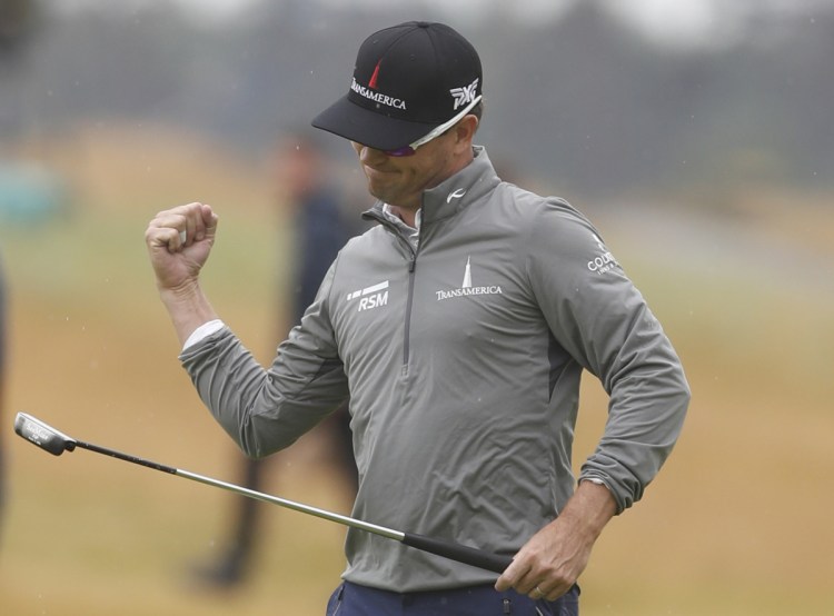 Zach Johnson of the United States celebrates after putting on the 18th green during the second round of the British Open golf championship in Carnoustie, Scotland, on Friday. (AP Photo/Alastair Grant)