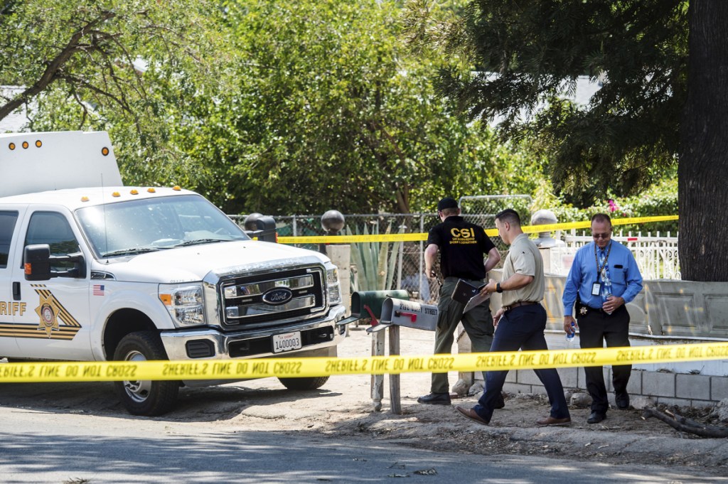 San Bernardino County Sheriff's personnel investigate the scene of a fatal shooting on Friday in Muscoy, Calif. Authorities say a 4-year-old boy accidentally shot and killed his 2-year-old cousin at a home in Southern California.