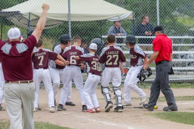 The Saco Little League team celebrates at home plate after Henry Lausier hit a three-run homer to finish off an 11-0 win over Lewiston in the state final Wednesday in Machias.
