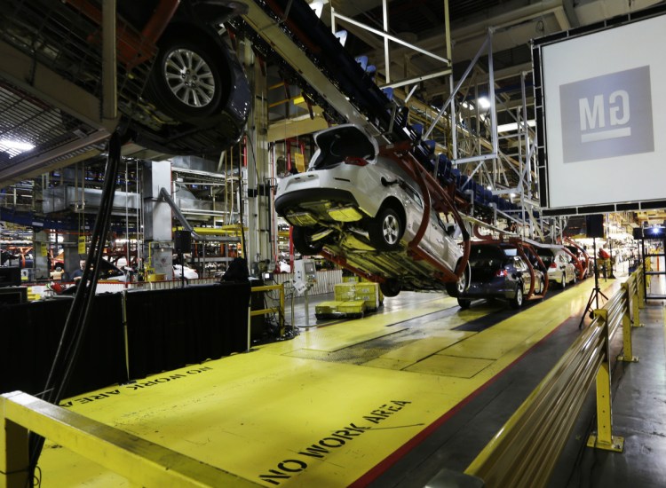 Cars move along an assembly line at a General Motors plant in Kansas City, Kan., in 2013. Analysts say that with too many factories making slow-selling cars, the automaker can't afford to keep them all operating without making some tough decisions.