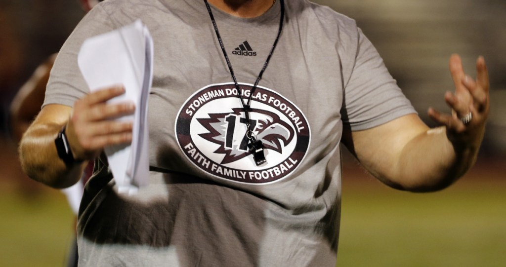 A coach wears a logo on his shirt honoring the 17 lives lost at Marjory Stoneman Douglas High School.