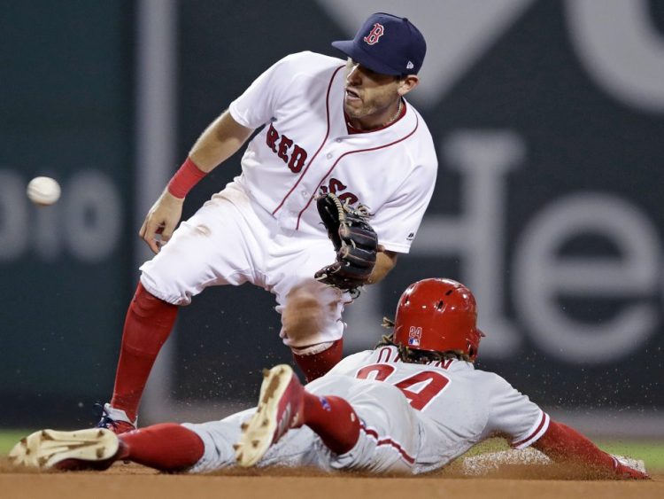 Boston's newly acquired second baseman Ian Kinsler, top, fields the throw as Philadelphia's Roman Quinn is caught trying to steal second Tuesday's game at Fenway Park in Boston.