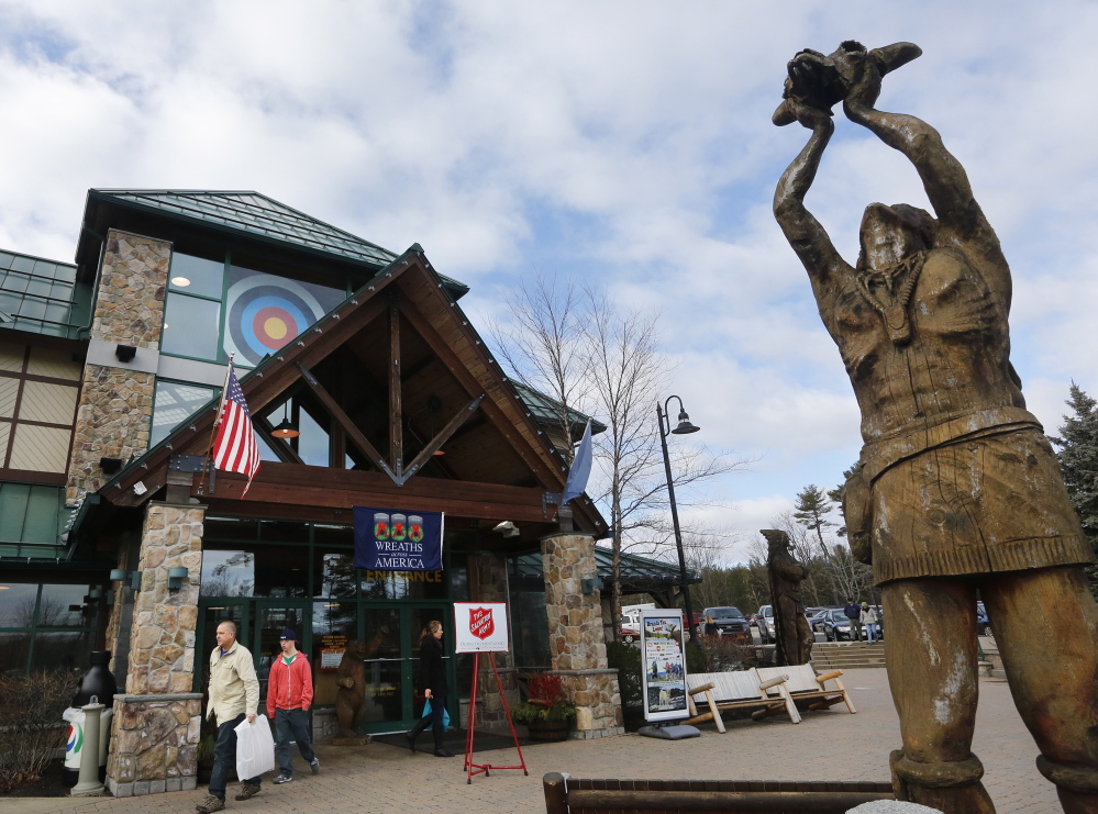 Shoppers carrying purchases leave Kittery Trading Post.