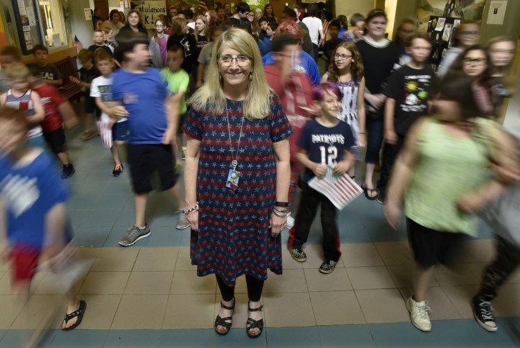 Vassalboro Community School Principal Dianna Gram stands in the hallway of the school as students file outside for a Flag Day celebration on June 14. Gram is retiring after some four decades as an educator and administrator.
