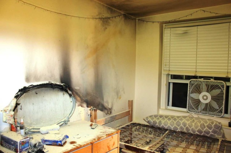 The walls and ceiling of a Colby College dormitory room appear black and damaged from a fire and smoke that broke out early Tuesday morning. A student living in the room told investigators that she fell asleep after lighting a candle.