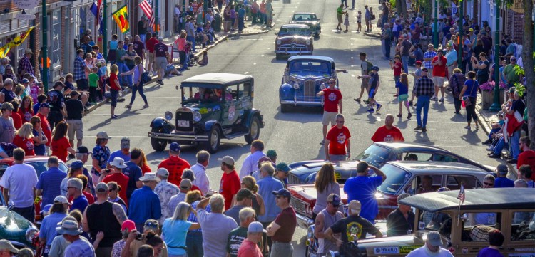 People watch on Tuesday as several Great Race cars come arrive June 26 on Water Street in Gardiner.