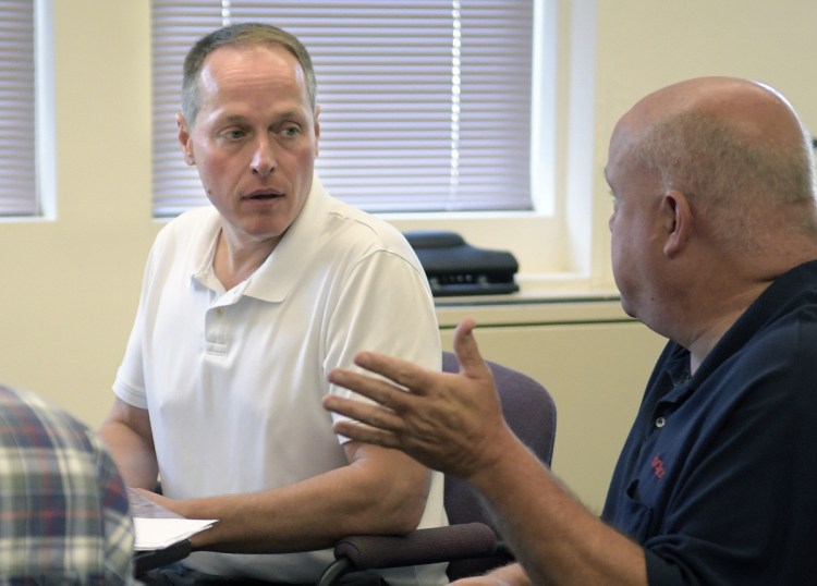 Winthrop Town Manager Ryan Frost, left, meets with town officials, including Fire Chief Dan Brooks, on Tuesday at the Town Hall. Winthrop Town Manager Ryan Frost plans to return to the position of police chief, after having left that job a year ago to take the town manager's position.