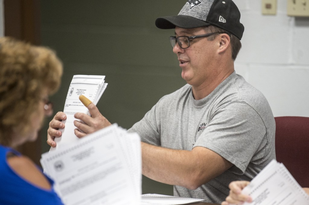 Todd Fredette, a representative of the 'yes' side of the school bond and budget issues who took part in a ballot recount Tuesday at the Town Office, and his 'no' partner, Kathy Aldridge, had to agree on the results of the recount for each 50-ballot batch before they could move on to the next batch.