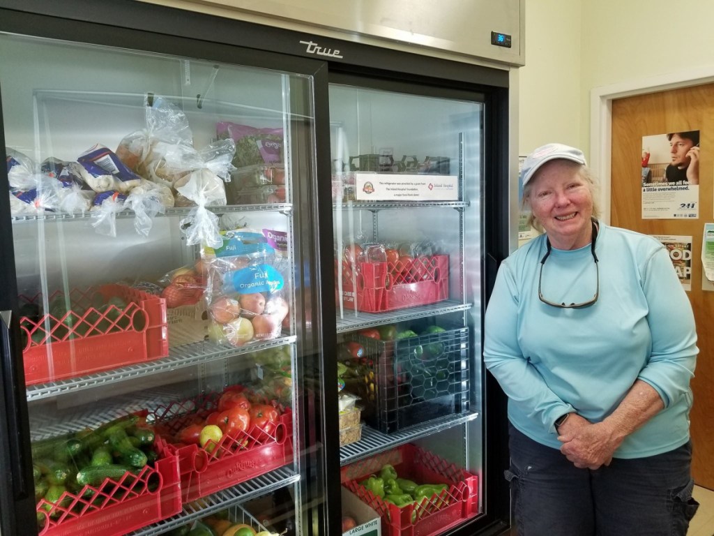 Sandy Hammond, operations manager of the Waterville Food Bank, with a new refrigerator donated by Inland Hospital's Community Benefit Grant Program.