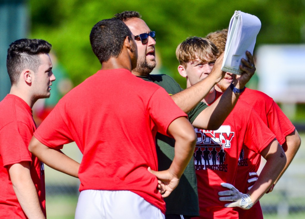 Cony coach B.L. Lippert gives his team a play in a game against Brunswick during a 7x7 tournament Friday in Turner.