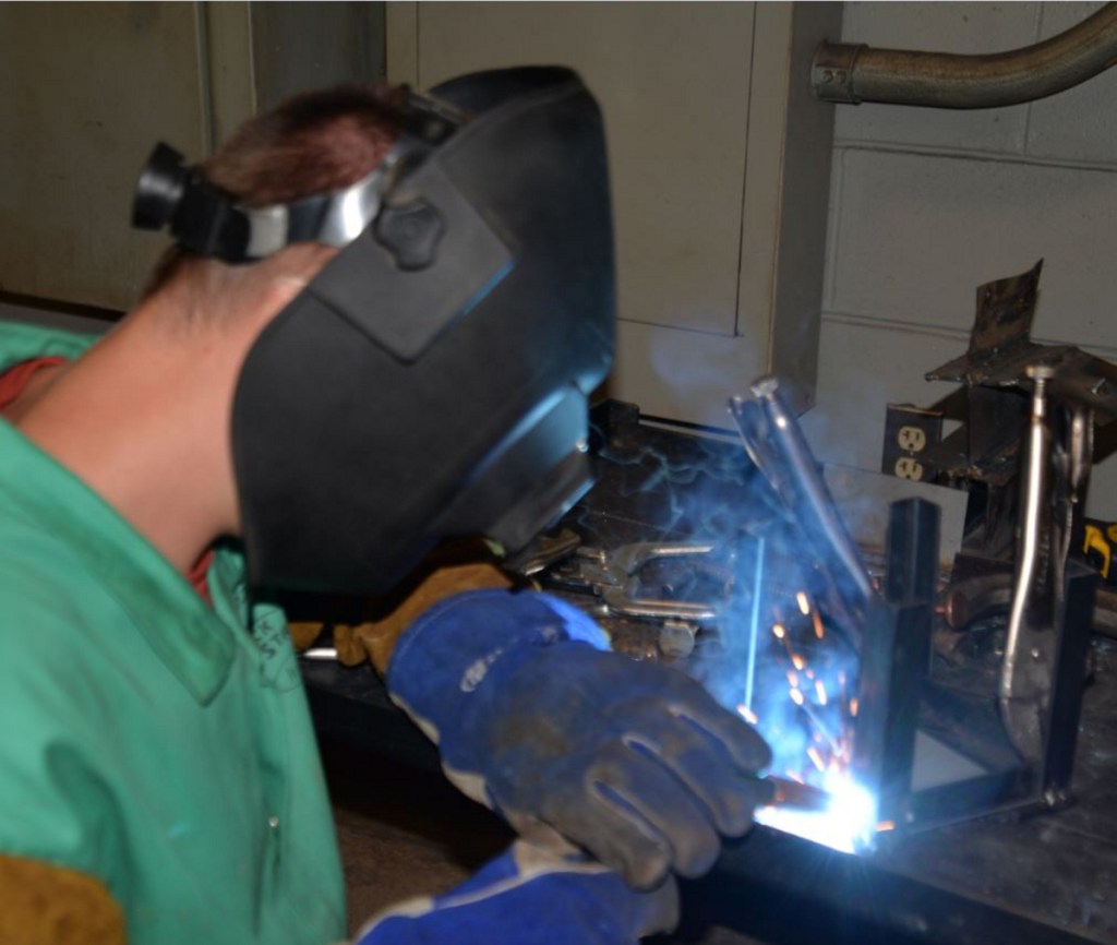 DJ Lorraine, a Messalonskee High School student, work on his welding project at the Welding and Fabrication Day Camp at Kennebec Valley Community College.