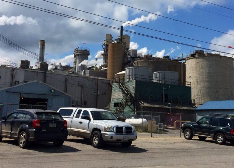 Workers' cars line the parking lot of the Androscoggin Mill in Jay in August 2015. Verso Corp., the company that owns the mill, announced Wednesday that it is making new investments in producing specialty paper at the mill.