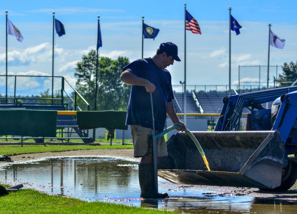 Staff photo by Joe Phelan
Al Cloutier pumps water from a puddle on Wednesday on McGuire Field in Augusta. Workers were preparing for the 2018 New England Regional Babe Ruth Baseball 13-15 year-old Tournament that will start on Friday and run through Wednesday.