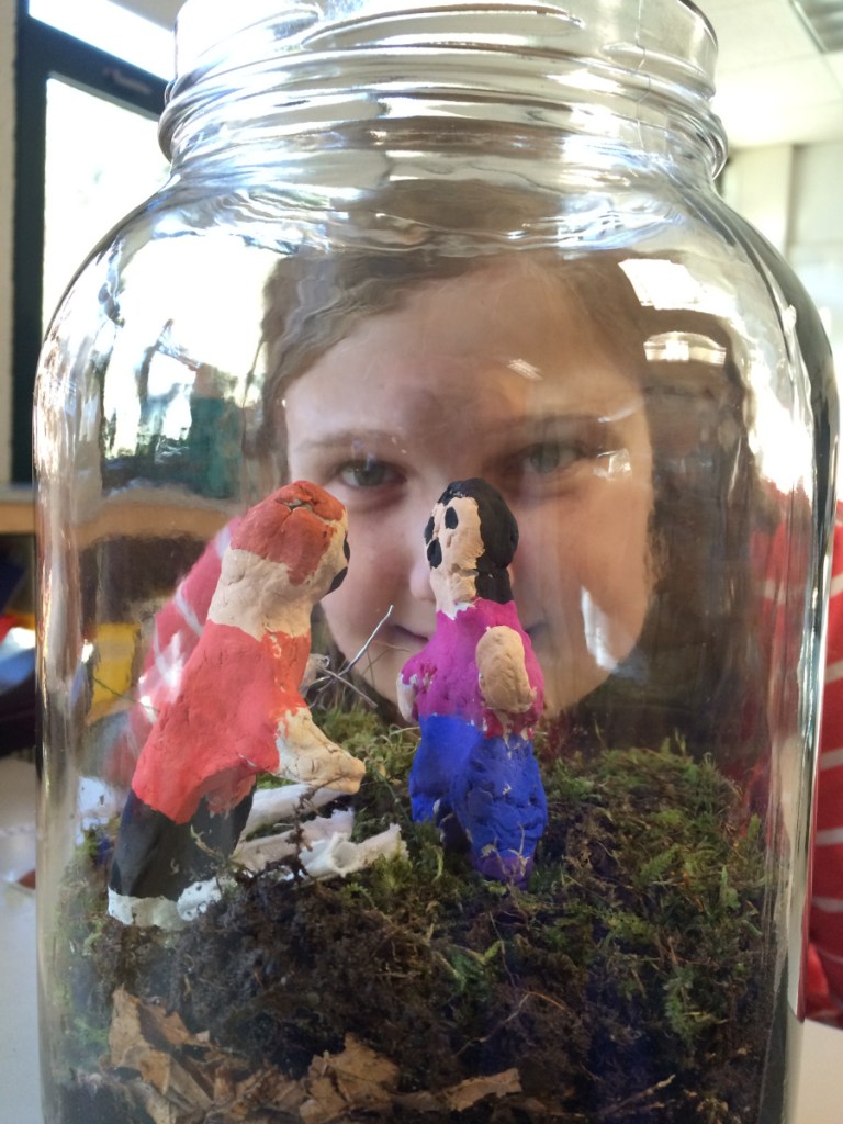 Riley Hager gazes into a literrarium she created for author Jack Gantos' Joey Pigza Swallowed the Key.