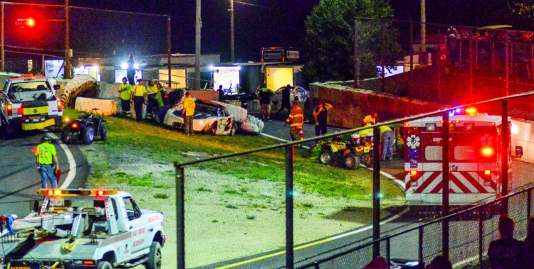 Emergency vehicles respond to a two-car crash involving Josh Bailey (2) and Mike Hodgkins, far right, in the Super Street feature on June 30 at Wiscasset Speedway.