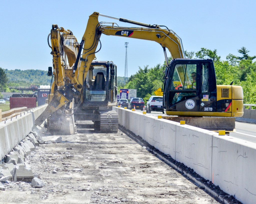 Wyman and Simpson employees work on re-decking an overpass that carries southbound traffic from Interstate 95's Exit 103 over the highway to the Interstate 295 toll booth on Wednesday in West Gardiner.