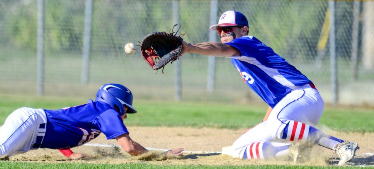 Waterford, Connecticut's Mike Marelli, left, dives back to first in time to beat a pick-off throw to Augusta first baseman Nick Barber during the Babe Ruth New England Regional tournament Friday in Augusta.