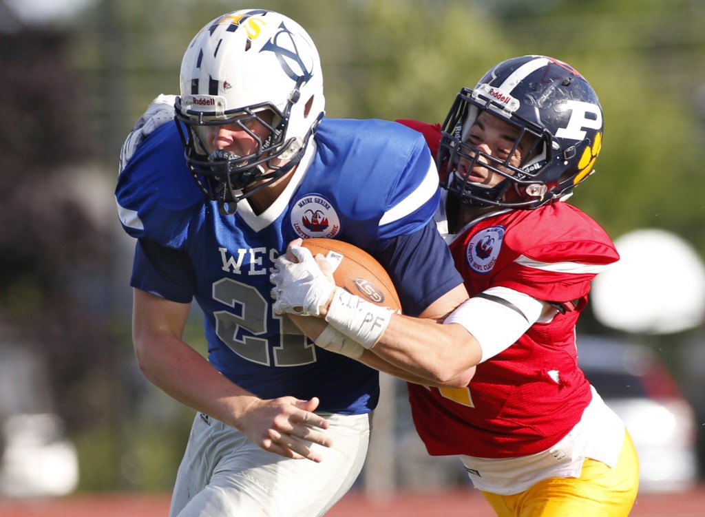 Vinnie Pasquali of Portland High School tackles West running back Jack True of Yarmouth in the fourth quarter during the Maine Shrine Lobster Bowl on Saturday in Saco.