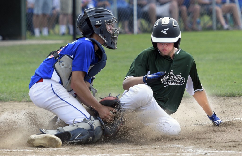 Augusta catcher Akira Warren tags Tri-County's Isaac Holland at home plate during the 13-15 New England Regional Babe Ruth tournament Monday in Augusta.