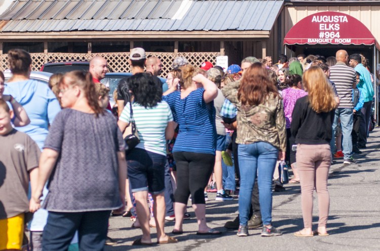The line stretches across a parking lot Aug. 26, 2017, before the door opened at the backpack and school supplies giveaway at the Augusta Elks Lodge.