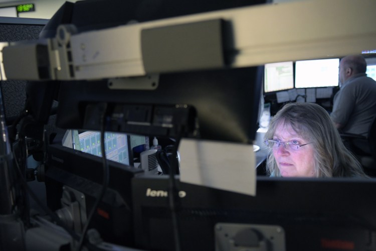 Department of Public Safety dispatchers communicate Thursday with firefighters, police and rescue workers at the Augusta agency. Only 14 dispatchers are handling emergency calls with a volume that previously has been handled by 35 dispatchers.