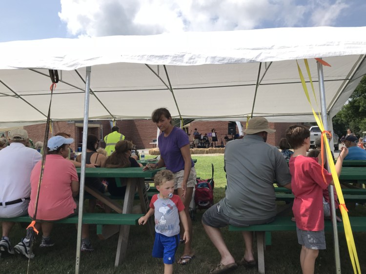 Families gather and listen to live music during the fourth annual OakFest on Saturday in Oakland, part of a three day festival that concludes with Paddle, Pedal, Pound the Pavement triathlon Sunday morning.