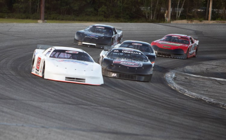 Cassius Clark, left, takes the lead ahead of Ray Christian during the PASS 150 on Sunday at Oxford Plains Speedway.