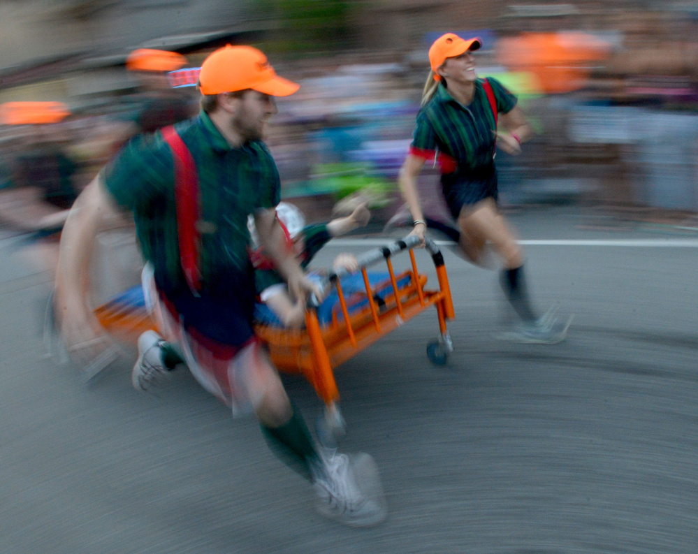 Team Skowhegan Savings Bank competes in the annual bed races in 2016 at Moonlight Madness as part of River Fest in downtown Skowhegan.
