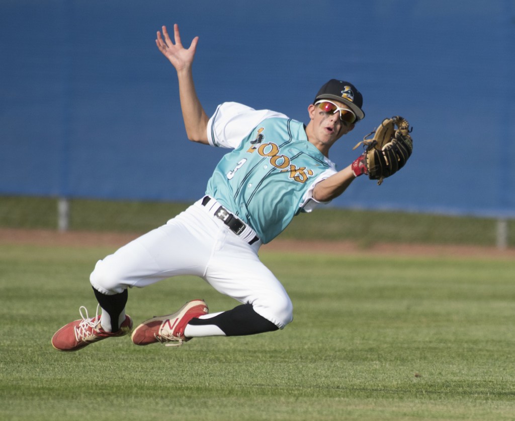 Messalonskee outfielder Jake Perry makes a sliding catch in the third inning of a Junior Legion state tournament game Monday against Fairfield at Mansfield Stadium in Bangor.